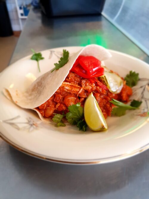 Tortilla gevuld met gestoofde kip, chorizo, tomaat, witte bonen en paprika