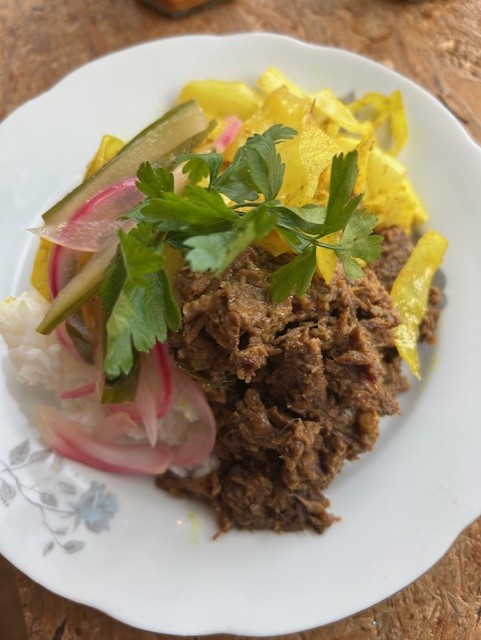 Rendang met gele rijst, geblancheerde kool en een gekookt ei